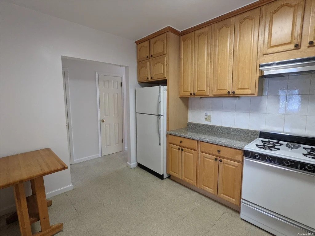 Large kitchen with white appliances