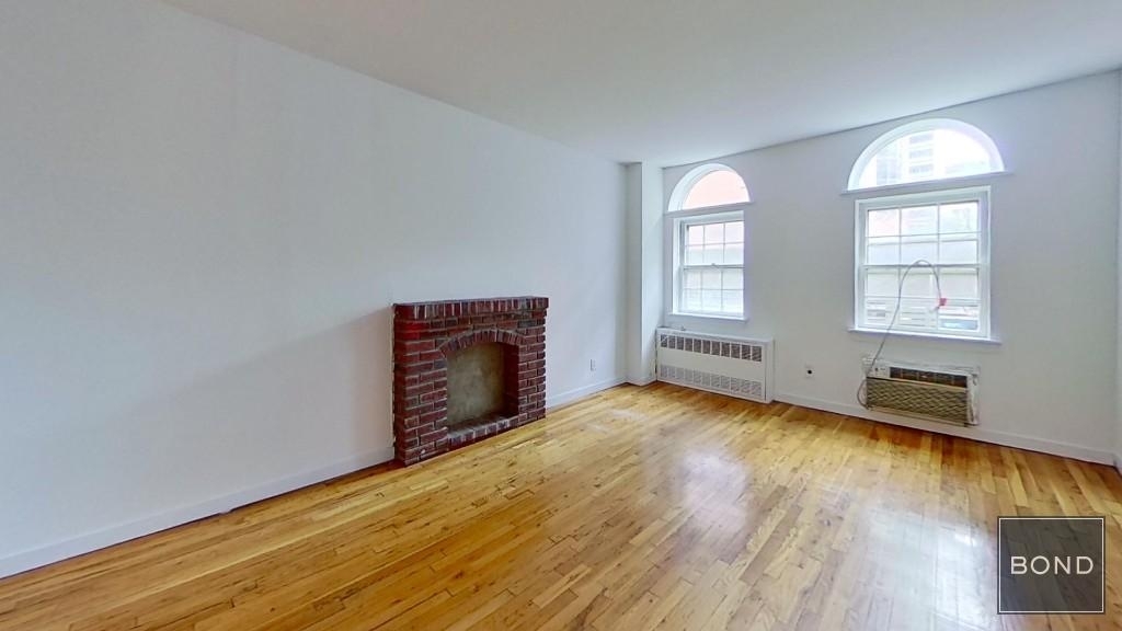 Living room with exposed brick and windows in Manhattan