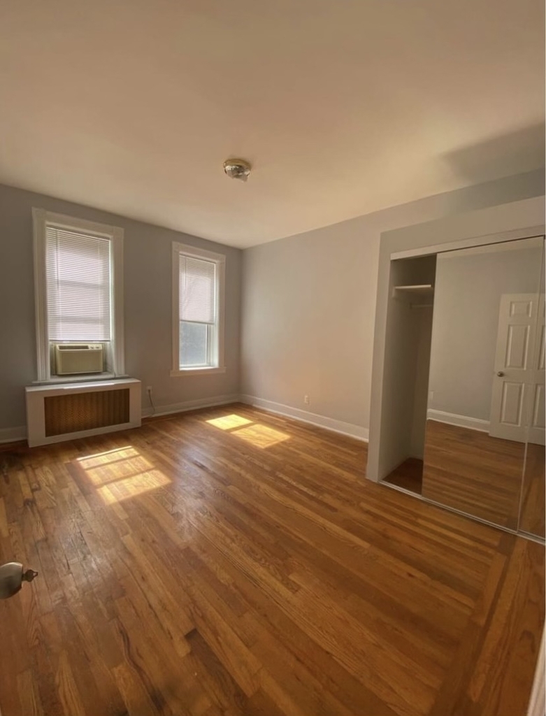Manhattan bedroom with two windows and closet