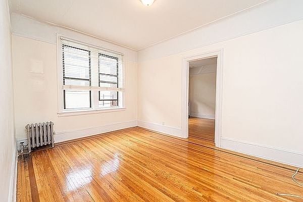 Living room in Queens with hardwood floors