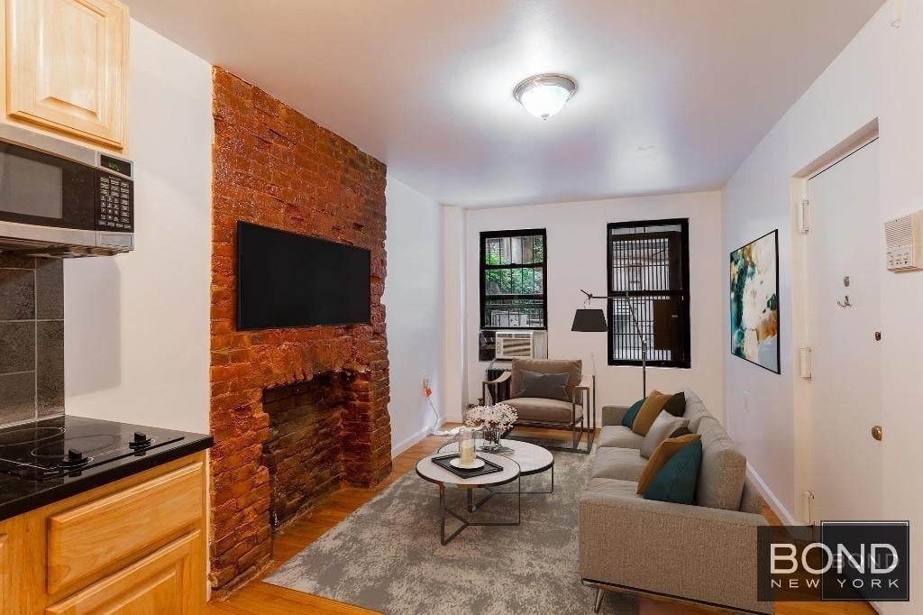 Studio with exposed brick fireplace