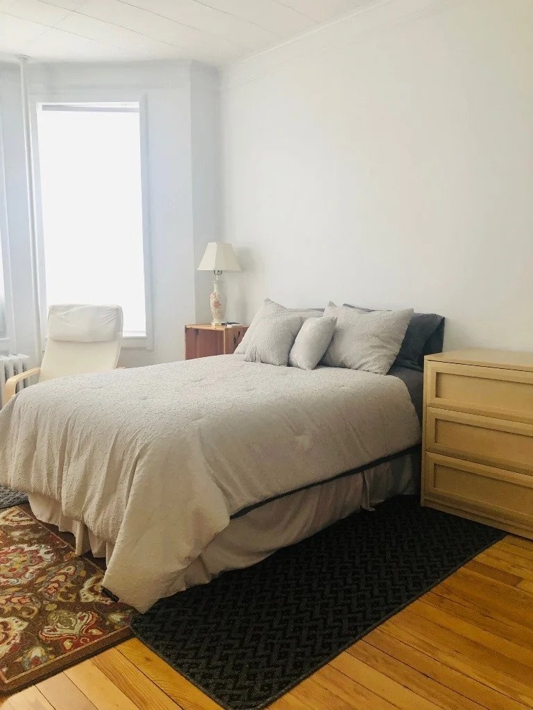 Bedroom with multiple windows in Queens