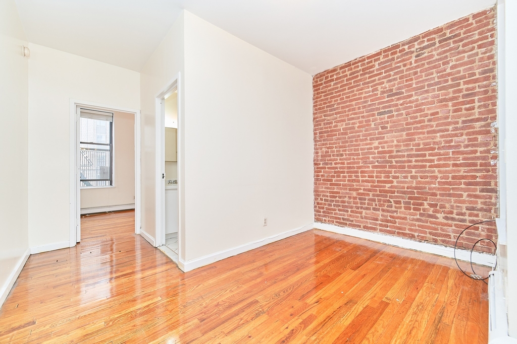 Manhattan apartment living room with exposed brick in February 2024