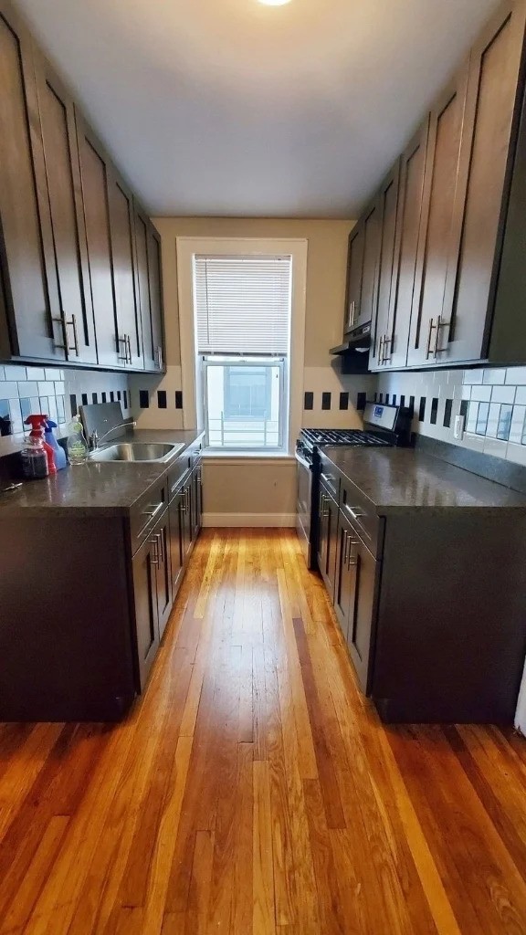 Queens apartment kitchen with black appliances
