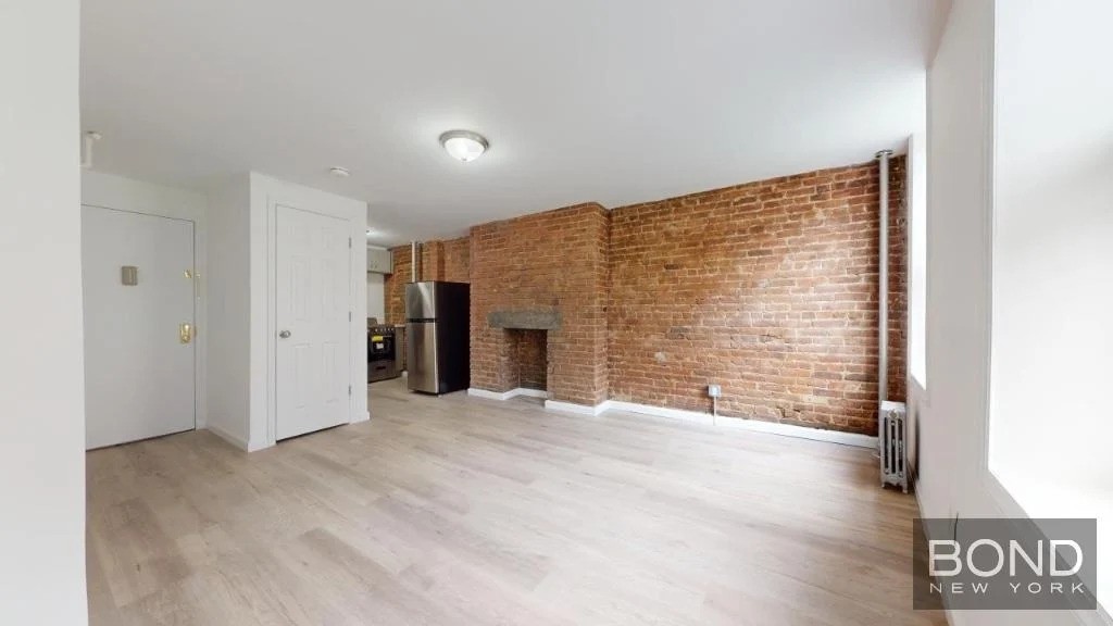 Manhattan studio with exposed brick fireplace