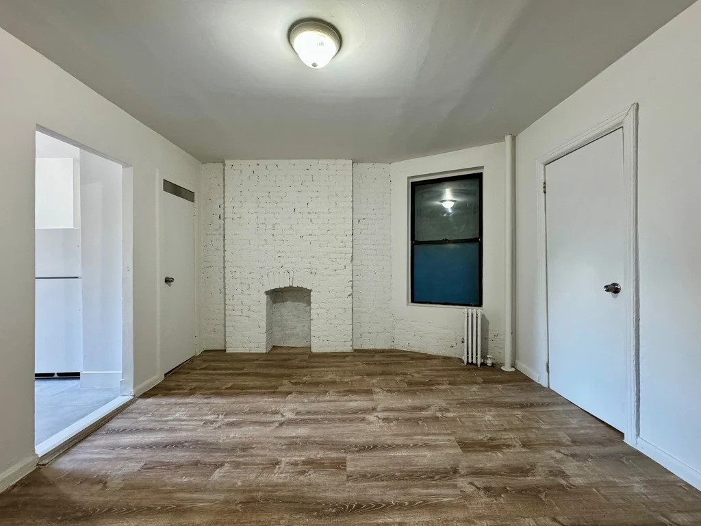 Living room with exposed brick fireplace