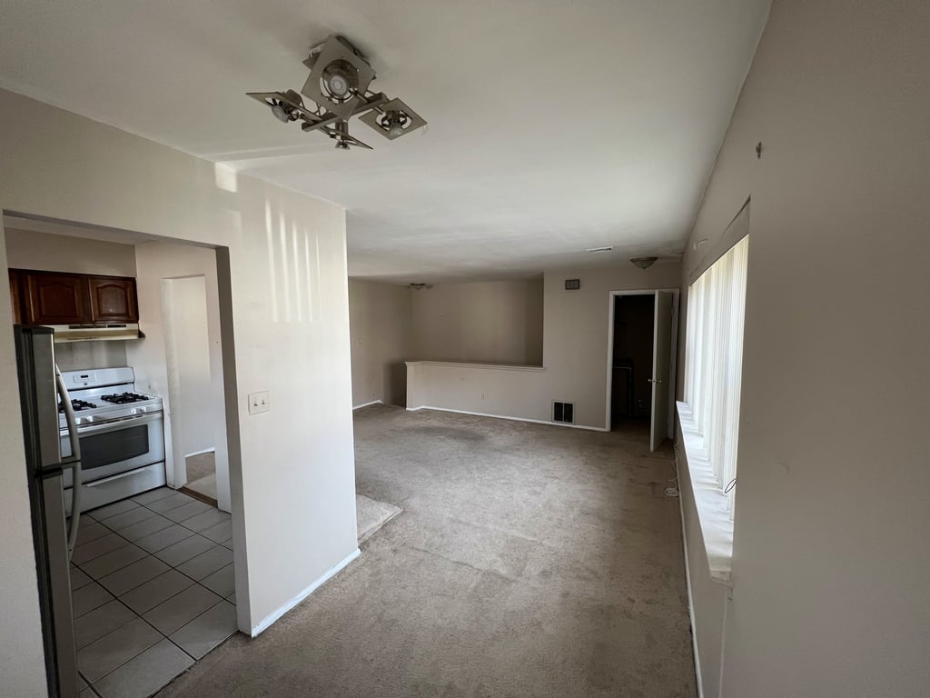 Carpeted living room in a Queens apartment
