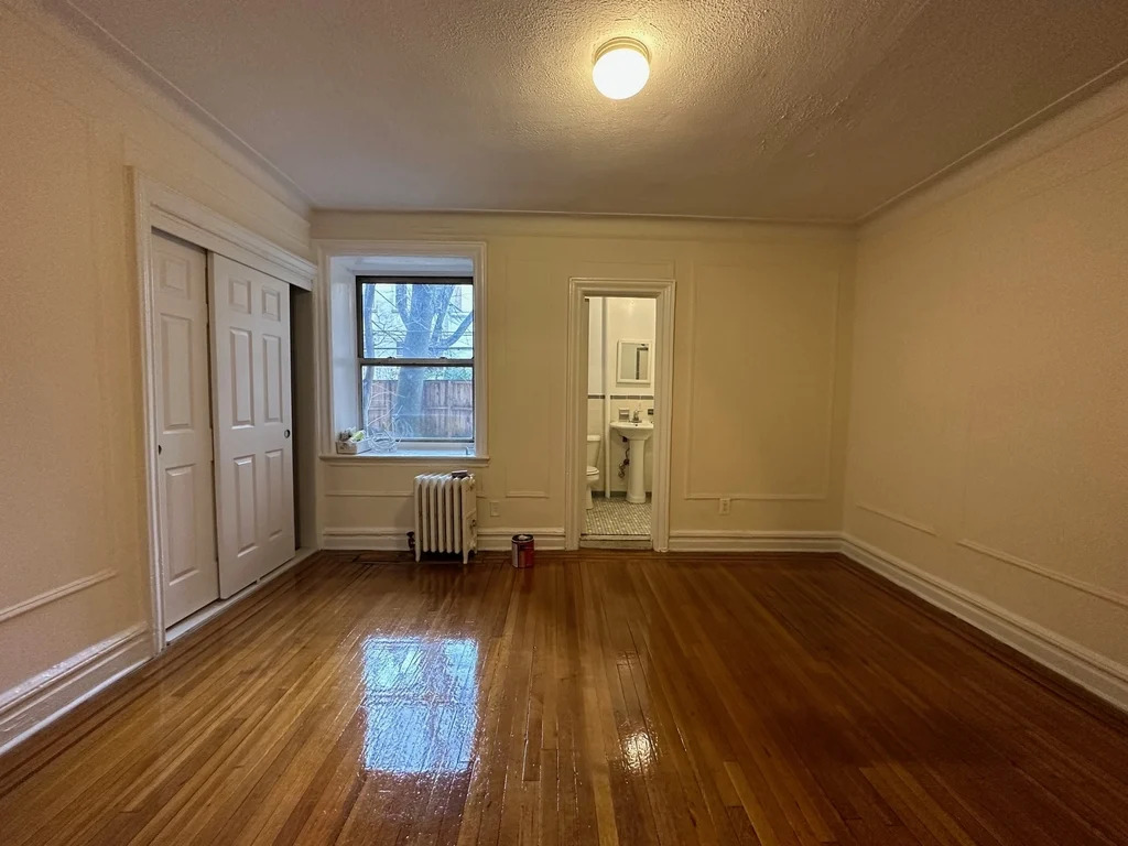 Spacious Brooklyn living area with hardwood floors