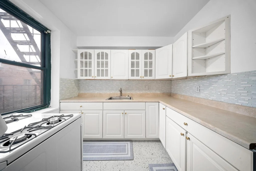 Queens kitchen with white appliances and cabinets