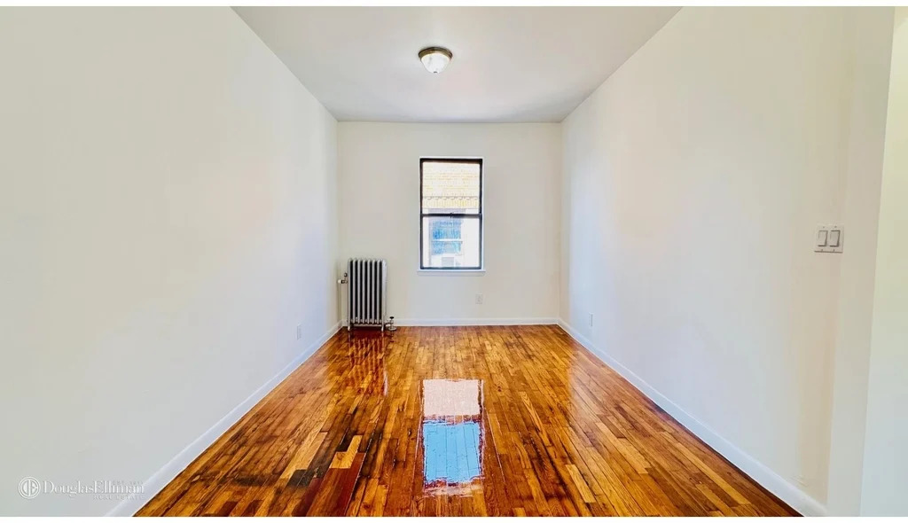 Bedroom in June 2025 with hardwood floors