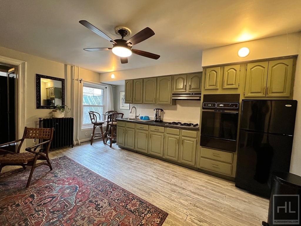 Brooklyn kitchen with green cabinets in July 2025