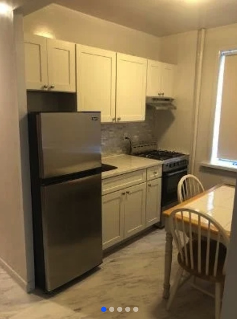 apartment listing photo of the kitchen space with dining table