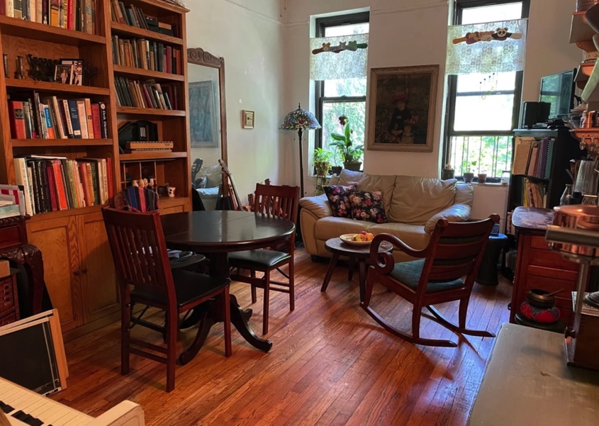 apartment photo with living space and library with books