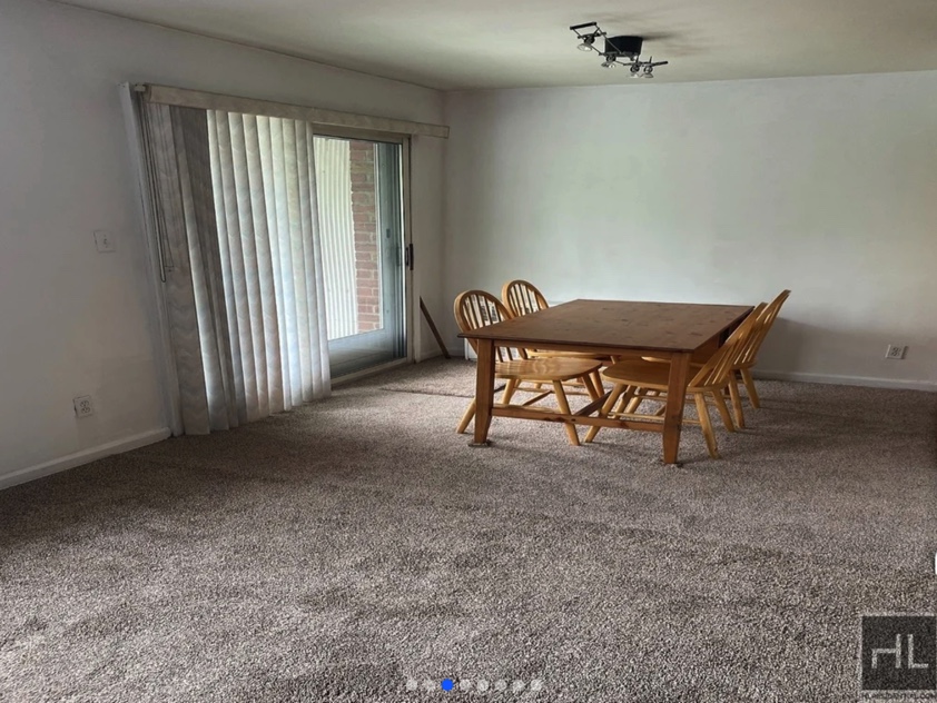 apartment listing photo of empty room with table and chairs