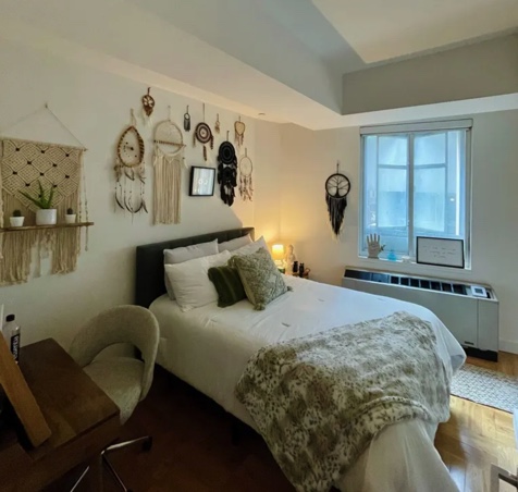photo of two bedroom apartment with bed and wall decorations