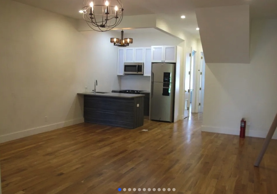 apartment listing photo of kitchen and empty living room