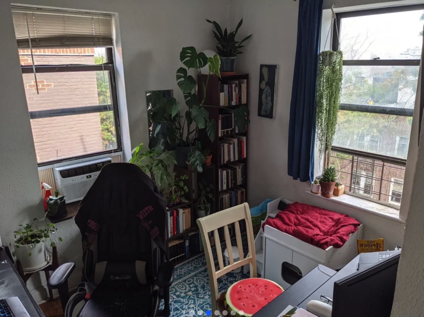 apartment listing photo of office space with books, desks, and chairs