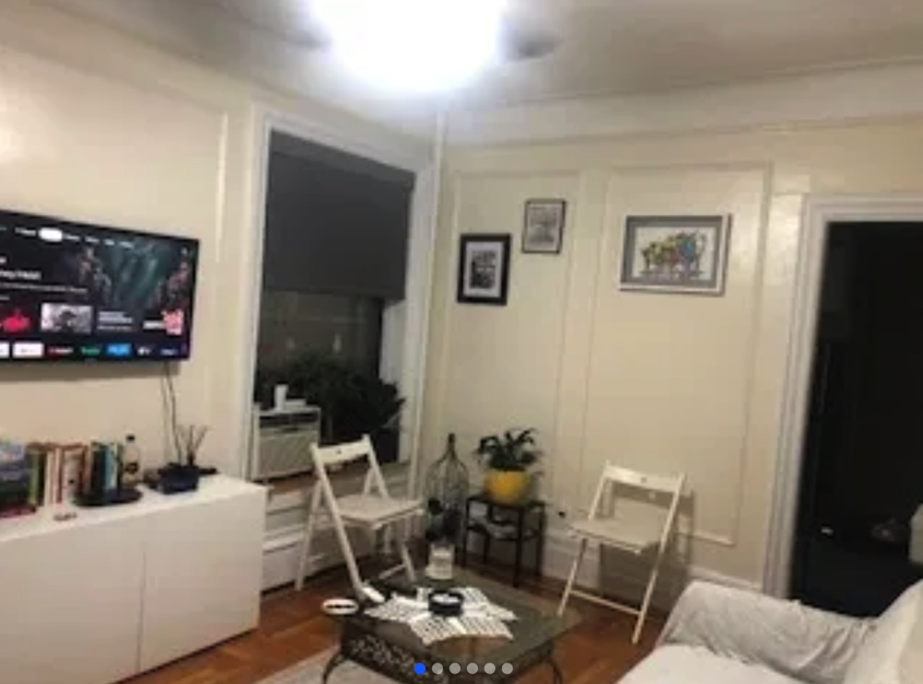 apartment photo of living room, two chairs, coffee table, sofa, and tv