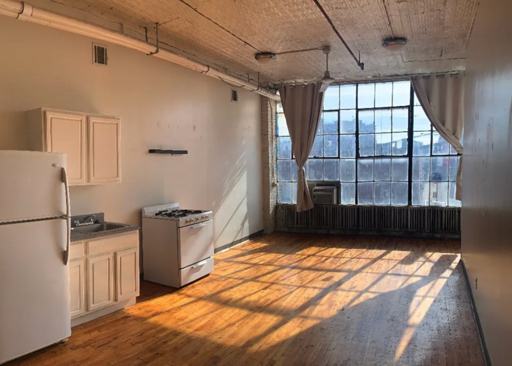 photo of kitchen with empty living room