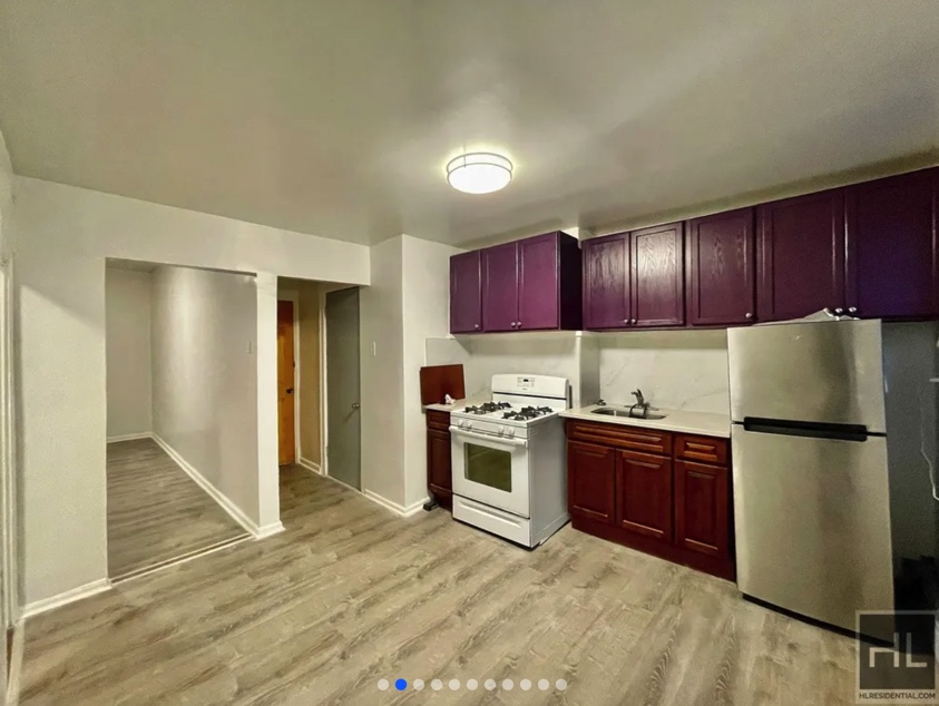 apartment listing photo of empty kitchen and hallway