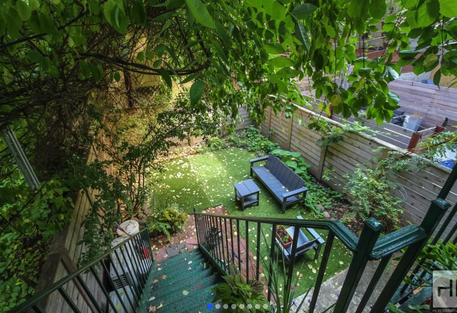 apartment listing photo of backyard with trees and grass