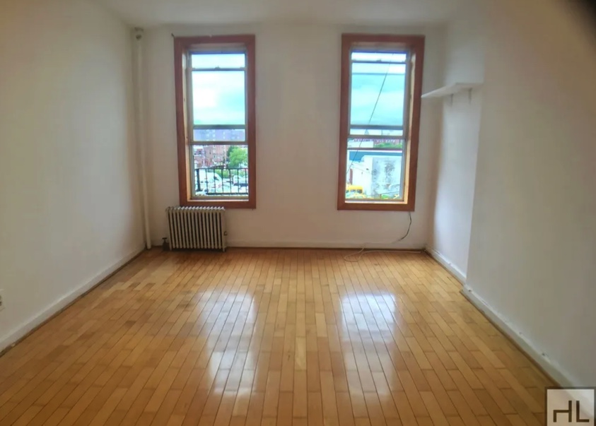 apartment listing photo of empty room with two windows
