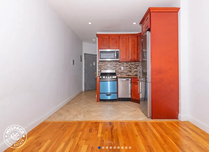 apartment photo of empty kitchen and front door