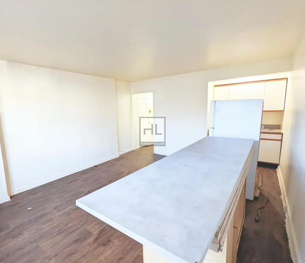 apartment listing photo of empty kitchen under renovations