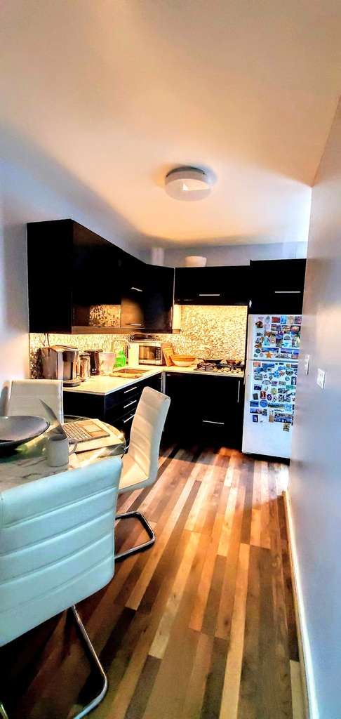 apartment photo of hallway with dining table and kitchen