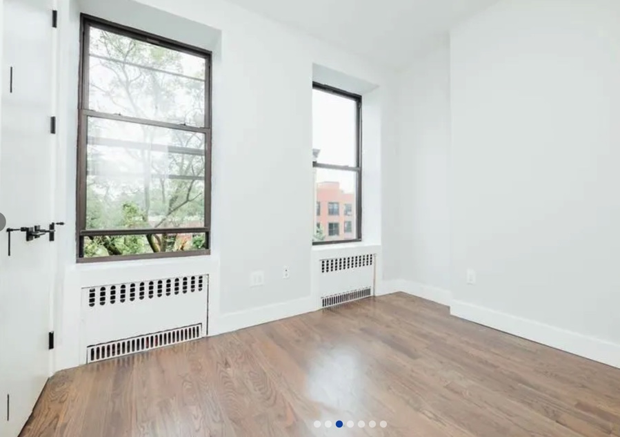 apartment listing photo of empty room with windows
