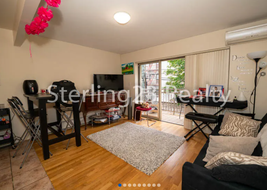 apartment listing photo of living room with sliding doors to balcony with funiture