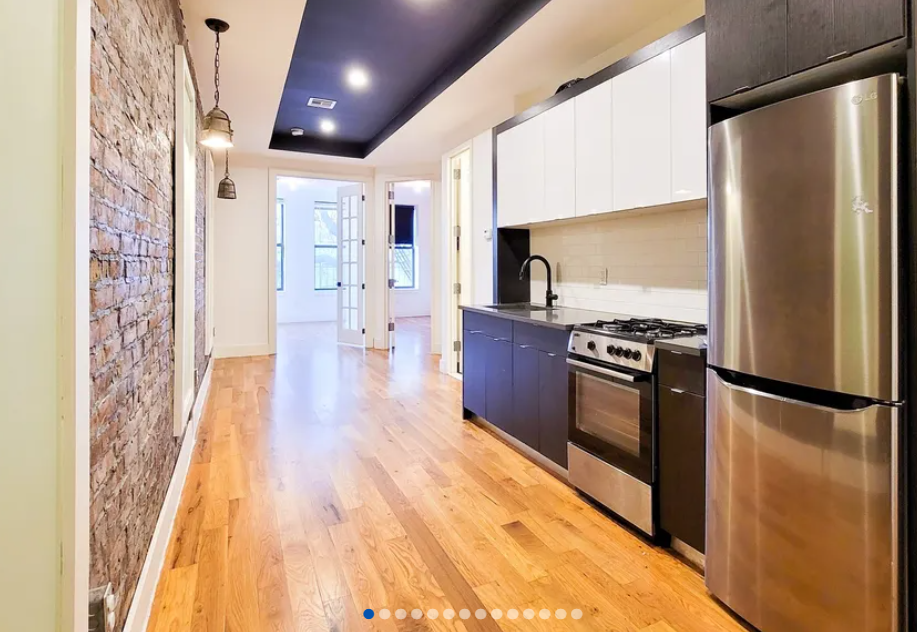 apartment listing photo of empty kitchen and hallway