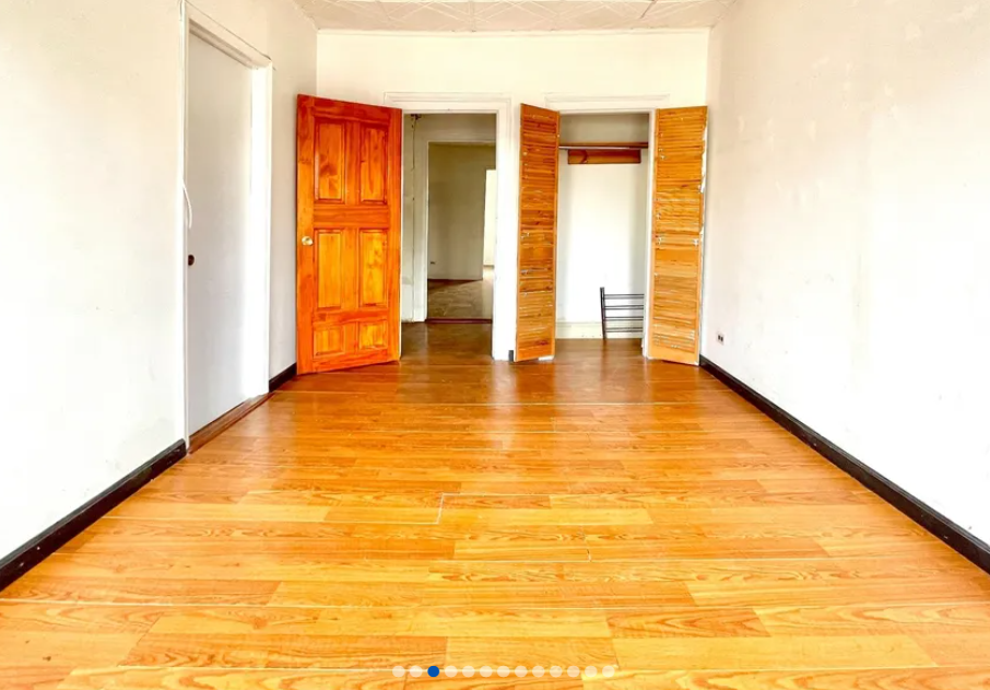 apartment listing photo of empty room with a closet