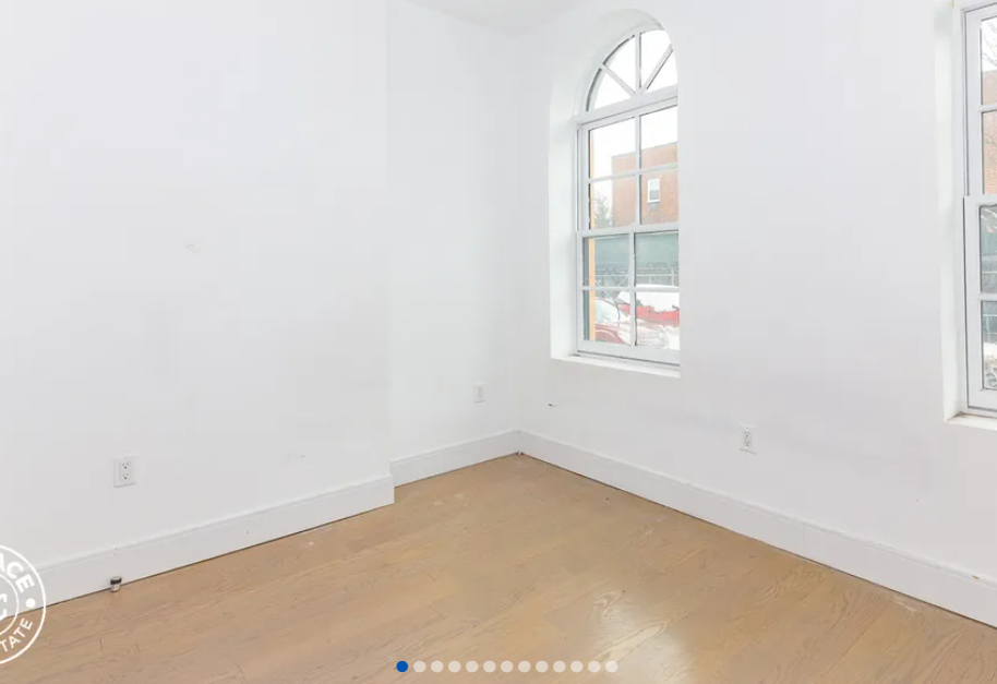 photo of empty room with two windows