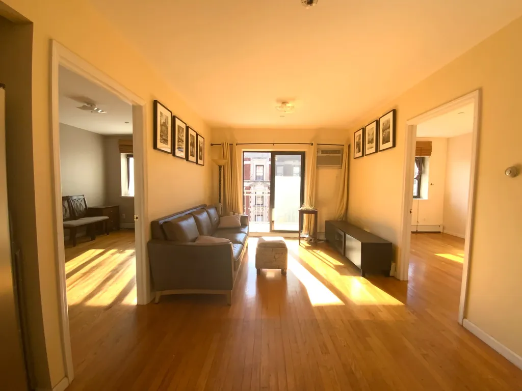 apartment listing photo of living room with the entrances to two separate rooms on both sides of the living room