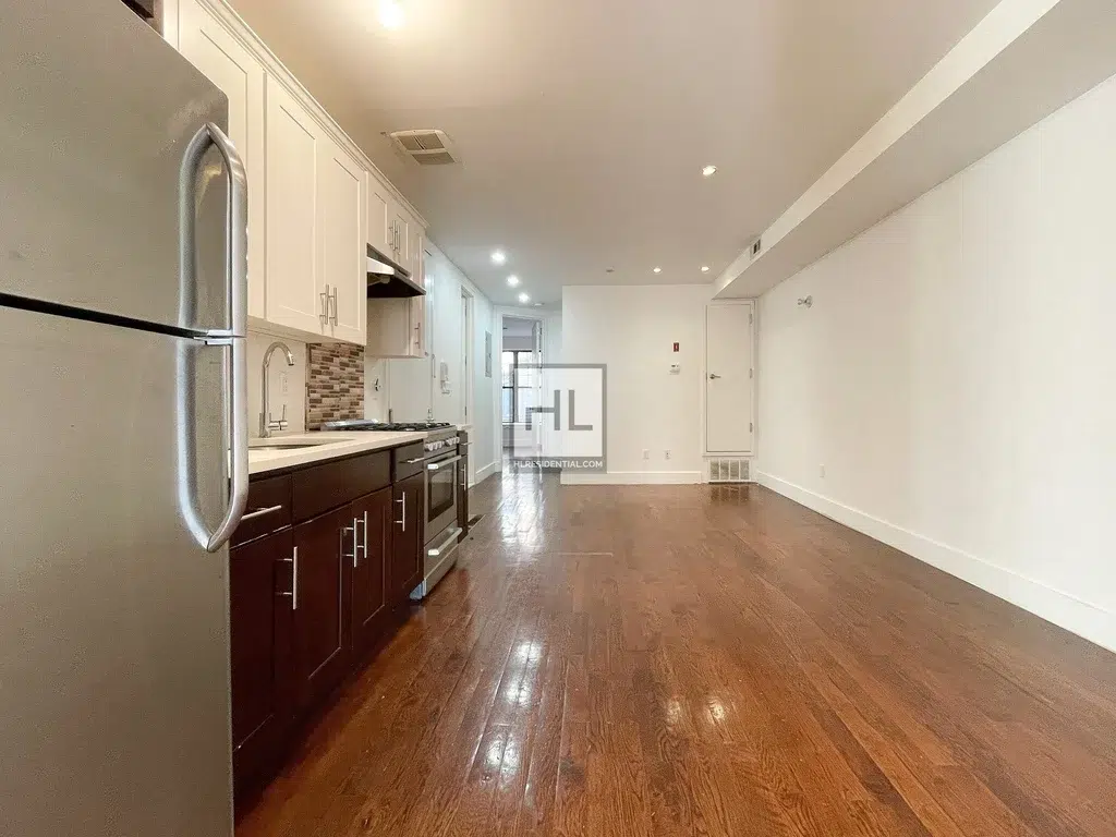 photo of empty room with open kitchen layout