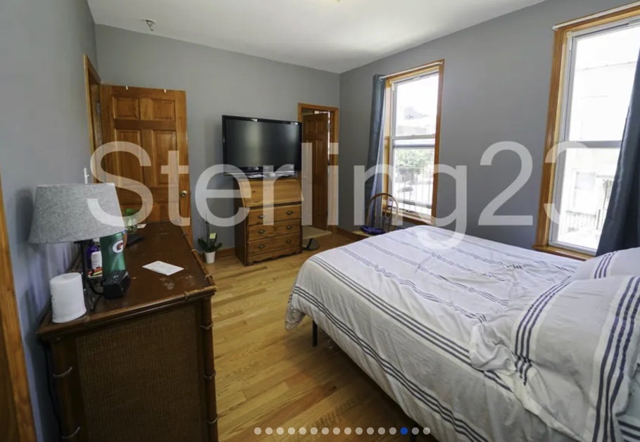 apartment listing photo of a furnished bedroom with bed and closet space