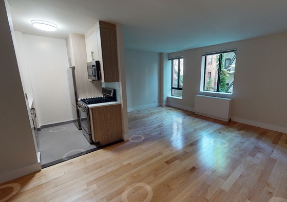 apartment photo of empty room with kitchen