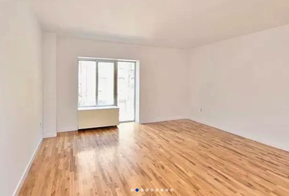 apartment listing photo of empty room with windows