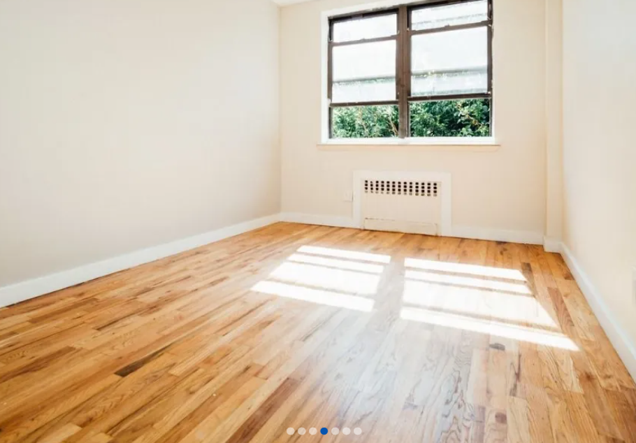 photo of an empty bedroom with large window