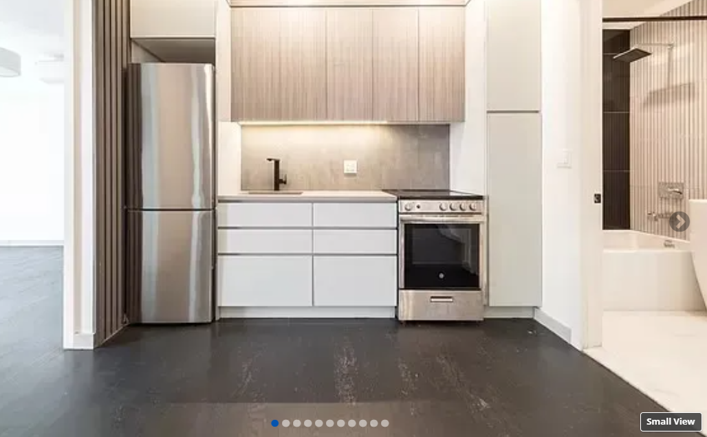 photo of kitchen and a bathroom on the side in the background