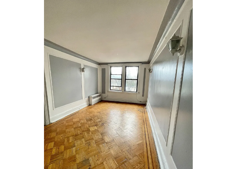 apartment listing photo of an empty room with windows