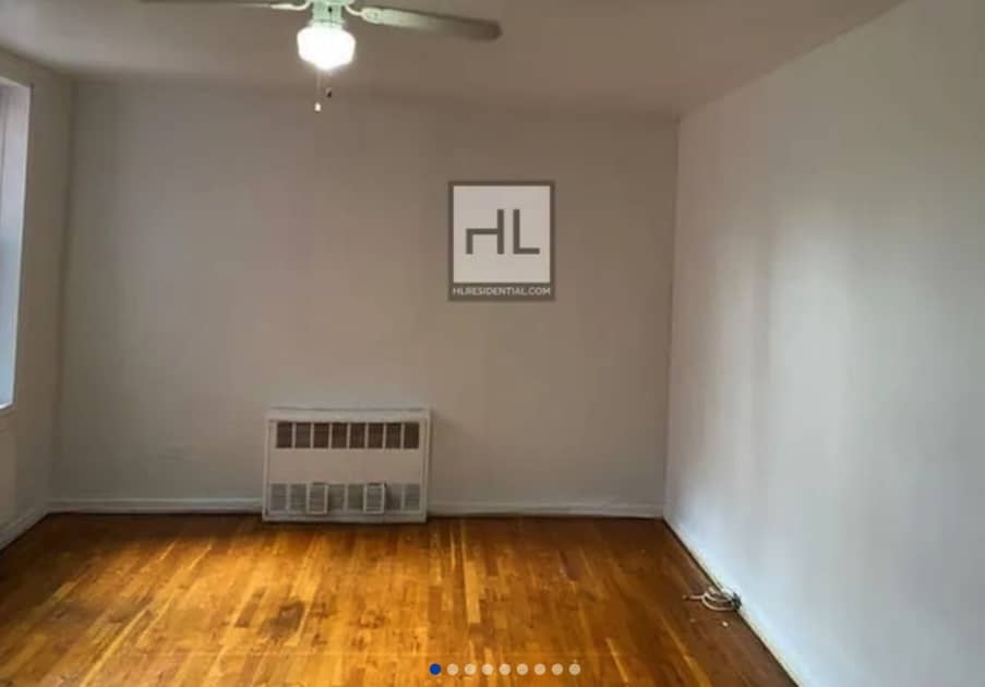 apartment listing photo of an empty room with ceiling fan and window