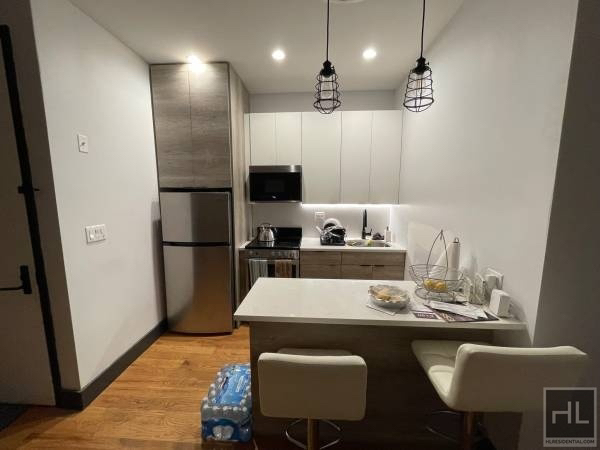 remodeled kitchen with counter space and barstools