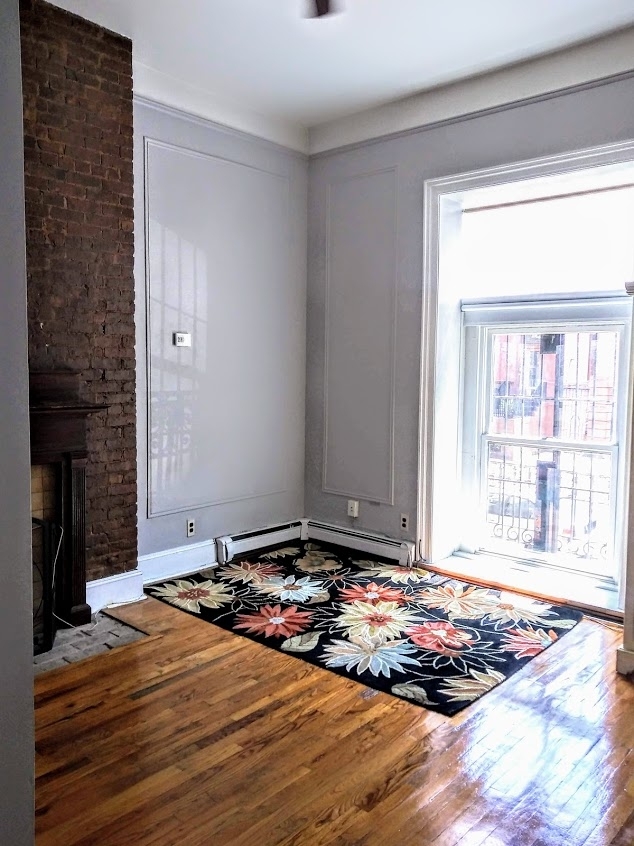 studio with brick fireplace and Juliet balcony