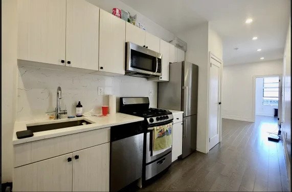 kitchen with stainless steel appliances and white cabinets
