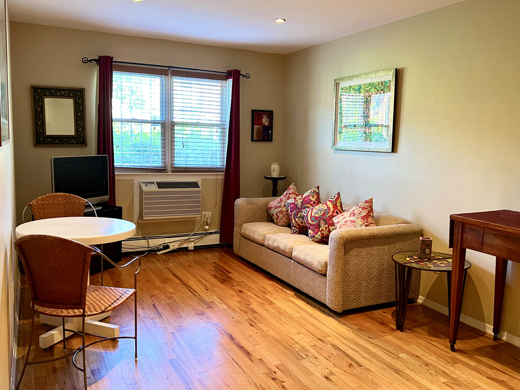 apartment listing photo of living room with sofa and chairs