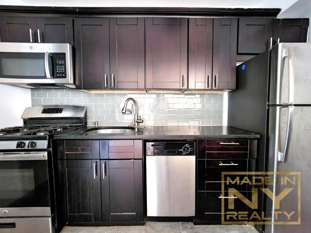 kitchen with dark cabinets and stainless steel appliances