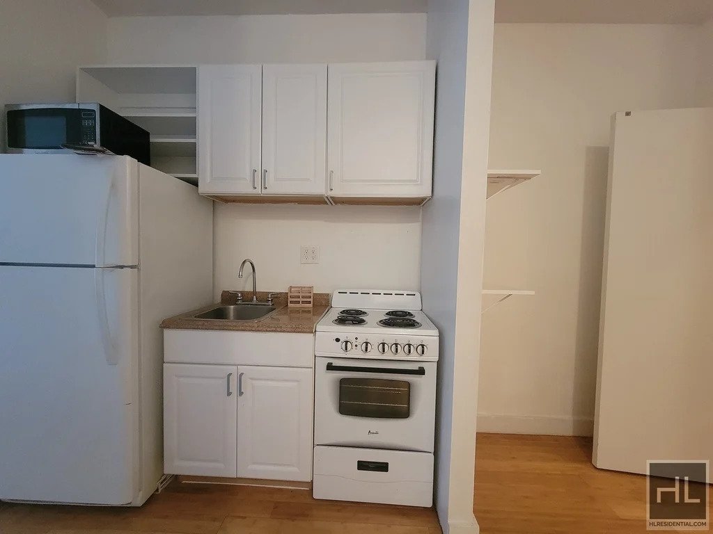 kitchen with white appliances and cabinets