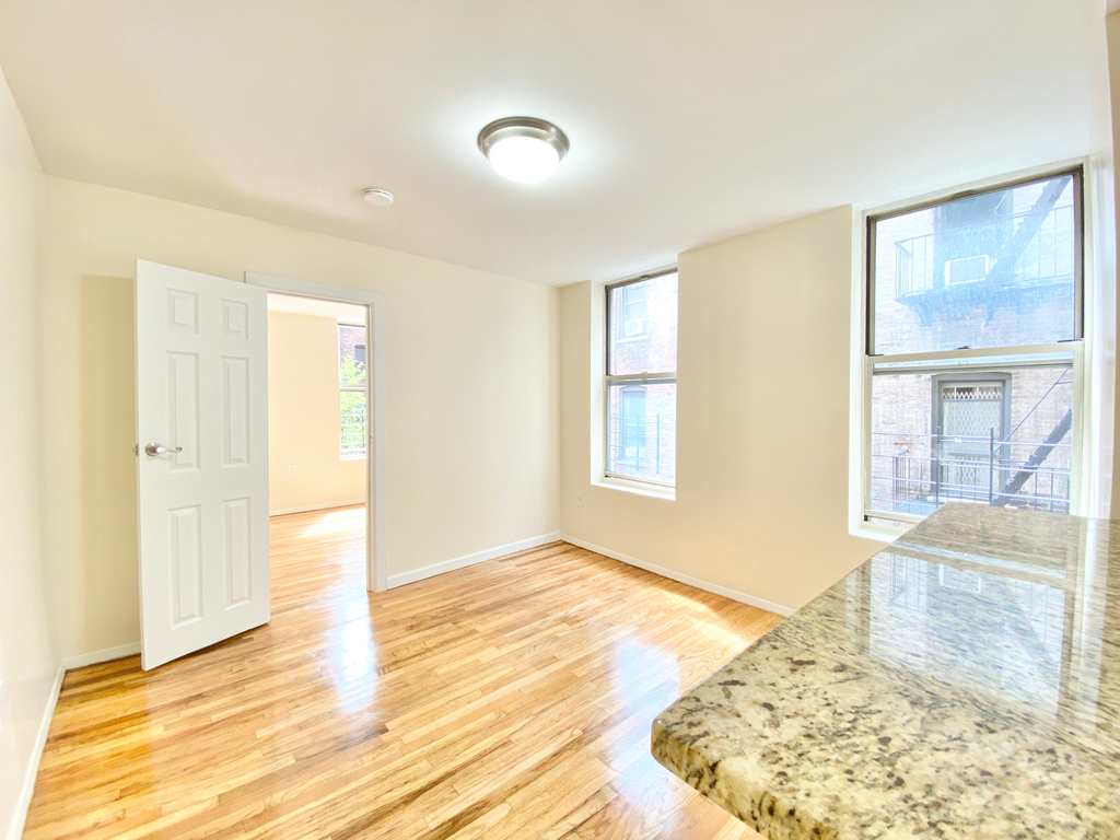 living room with glimpse of granite countertop in kitchen